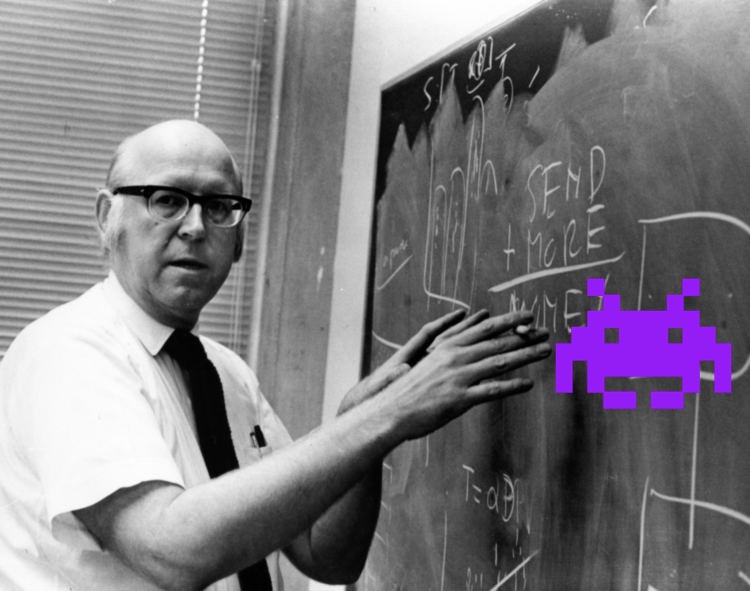 Photo of Allen Newell at a blackboard.